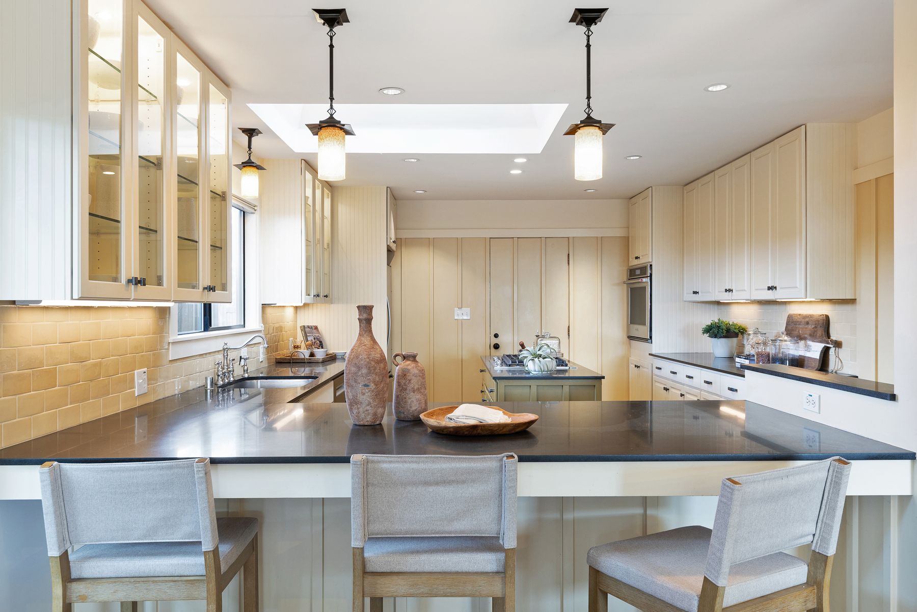 22 Kensington Court — kitchen with skylight, glass-front cabinets and peninsula seating