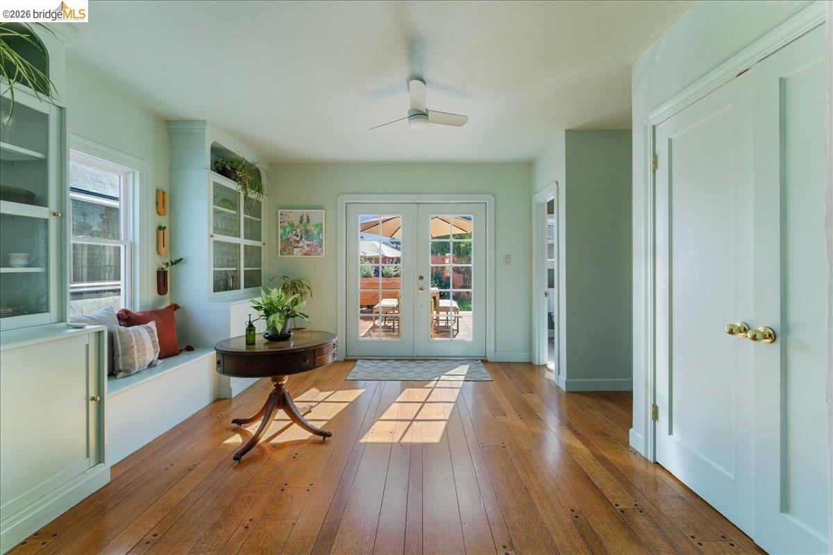 5327 Brann Street — mint-green dining room with built-in china cabinets, a window seat and French doors to the back deck